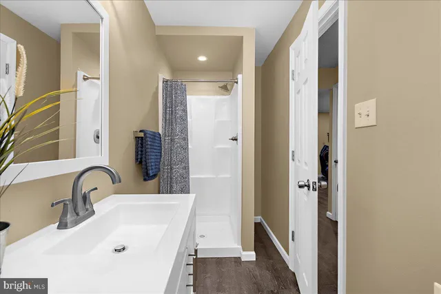 an aerial view of a house with swimming pool and large trees