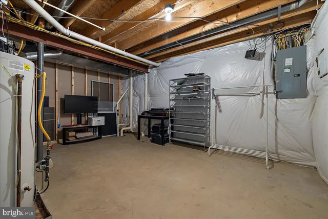 aerial view of a house with a yard and large trees
