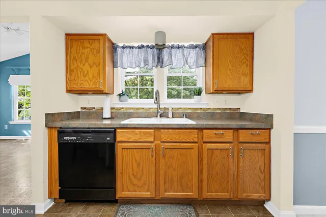 a kitchen with a refrigerator a stove dining table and chairs