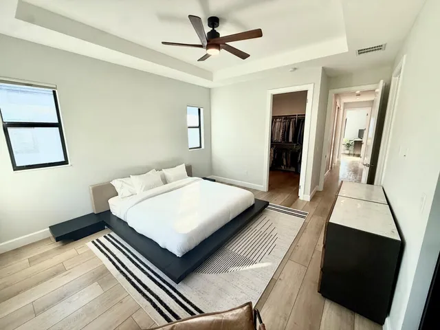 a bedroom with a bed and a flat screen tv