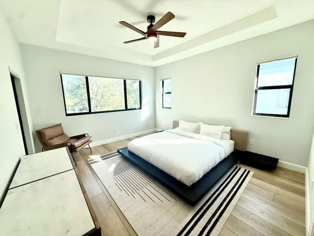 a bedroom with a bed and a chandelier