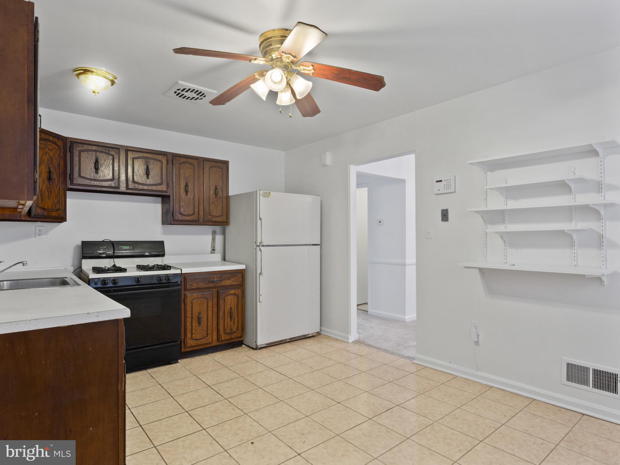 4008 24th Place Temple Hills, MD 20748 - Photo 16 of 31 a kitchen with stainless steel appliances granite countertop a refrigerator a stove a sink and a oven