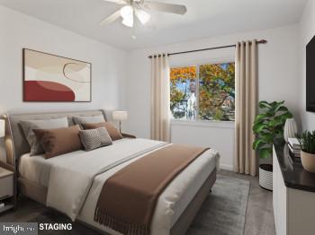 4008 24th Place Temple Hills, MD 20748 - Photo 20 of 31 a bedroom with a balcony a bed and a painting on the wall