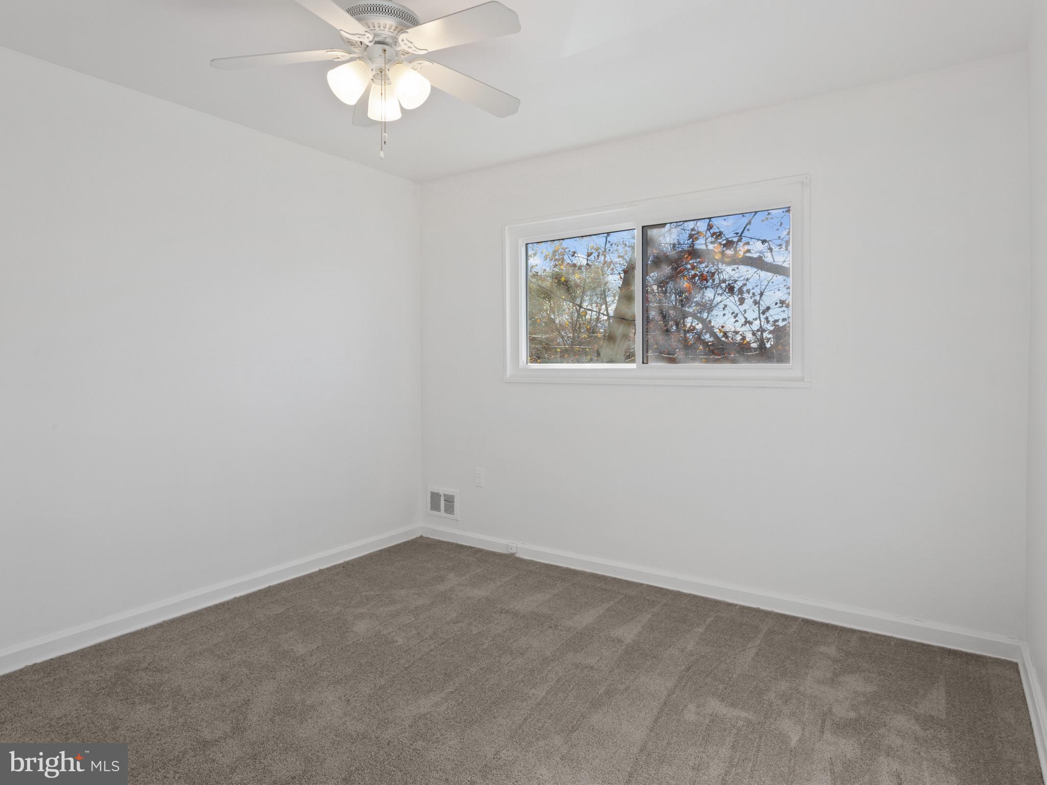 4008 24th Place Temple Hills, MD 20748 - Photo 24 of 31 an empty room with a window and a fan