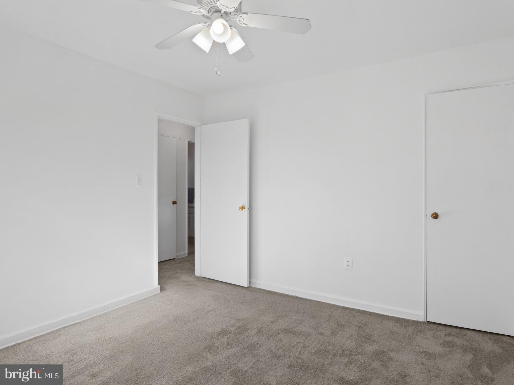 4008 24th Place Temple Hills, MD 20748 - Photo 25 of 31 an empty room with a chandelier fan