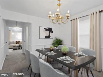 4008 24th Place Temple Hills, MD 20748 - Photo 10 of 31 a view of a dining room with furniture and chandelier