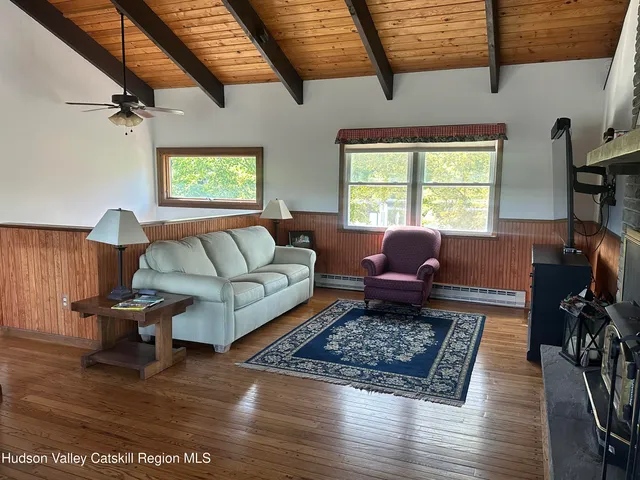 a view of a room with furniture and window