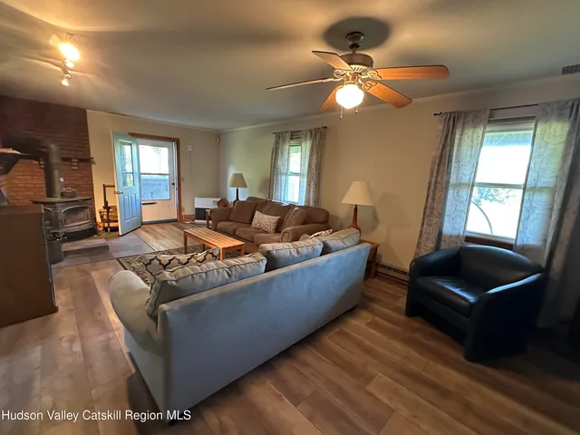 a living room with furniture and a lamp