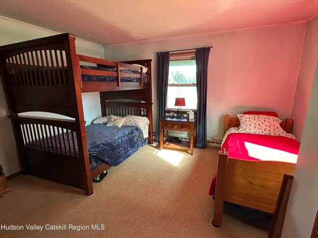 a living room with furniture a flat screen tv and a large window