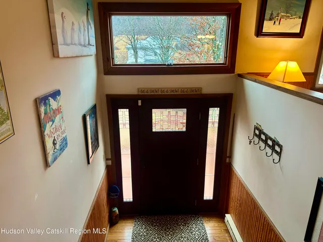 a dining room with furniture a flat screen tv and a large window