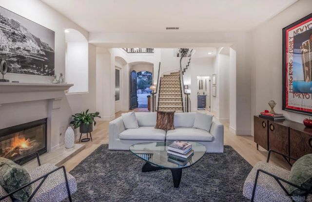 a bedroom with a bed dresser and window