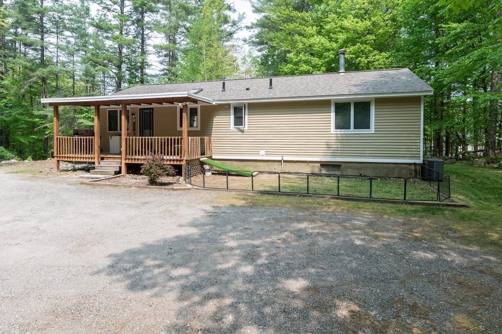 2 Rocky Hill Road Amherst, NH 03031 - Photo 32 of 36 a view of a house with backyard and sitting area
