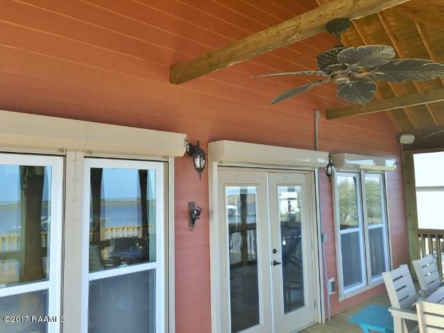551 Lake Breeze Road Hackberry, LA 70645 - Photo 8 of 36 Screened porch entry