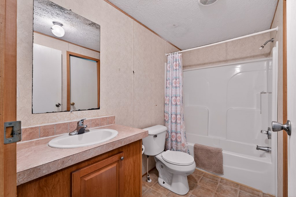 282 West Cherry Road Hayesville, NC 28904 - Photo 18 of 45 a bathroom with a granite countertop sink toilet and shower