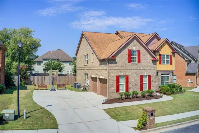 a front view of a house with a garden