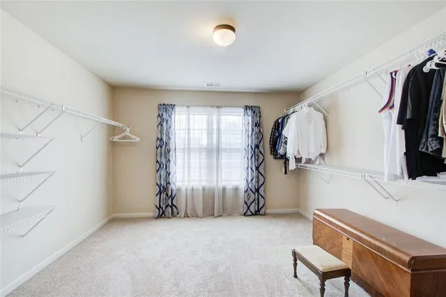 a bathroom with a bathtub a window and a shower