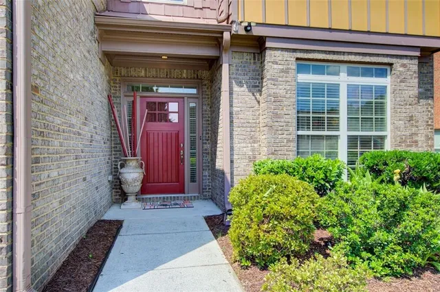 a living room with furniture a flat screen tv and a window