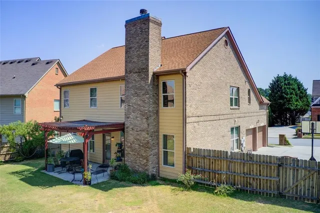 a view of a wooden house with a backyard