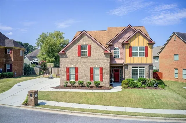 an aerial view of a house a yard and lake