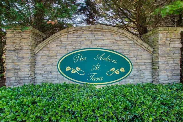 an aerial view of a house with a yard and greenery