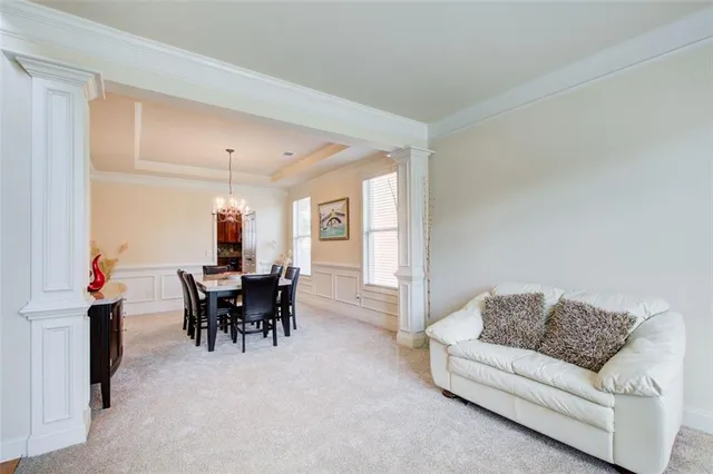 a view of a dining room with furniture and chandelier