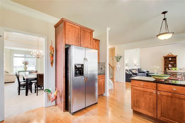 a kitchen with granite countertop a sink stove and cabinets