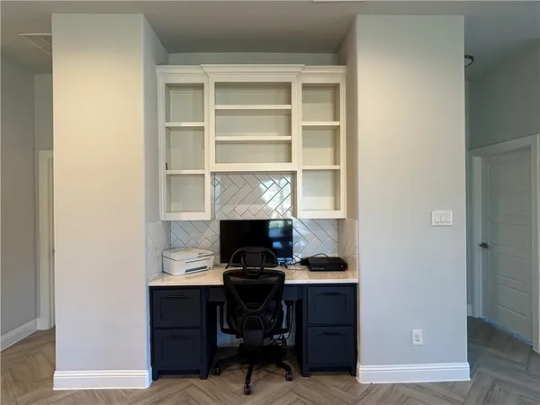 a kitchen with stainless steel appliances kitchen island granite countertop a stove a refrigerator a sink a dining table and chairs with wooden floor