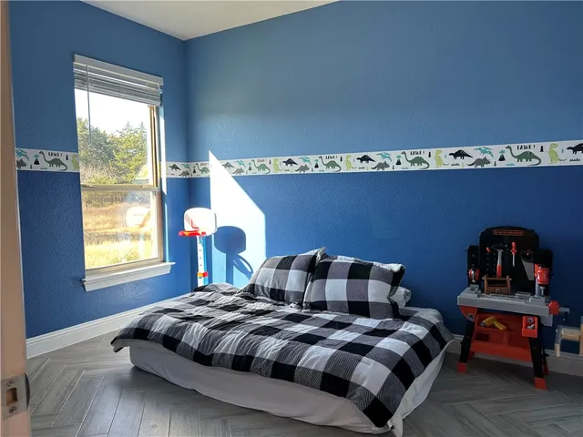 a bedroom with furniture and a window