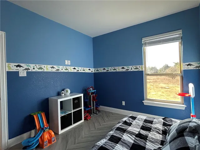 a bathroom with a granite countertop toilet sink and mirror