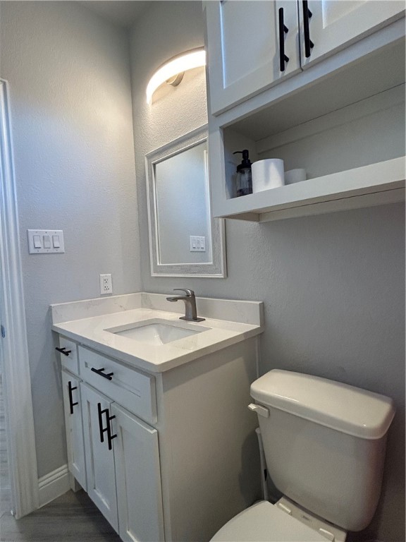 16664 County Road 3120 Road Northwest Purdon, TX 76679 - Photo 25 of 59 a bathroom with a granite countertop toilet sink and mirror
