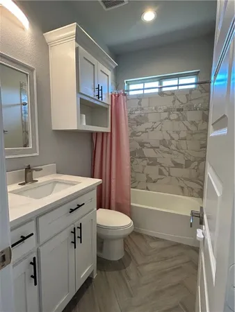 a bedroom with a bed and a tv