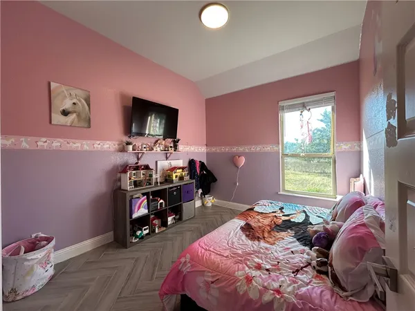 a bed room with bed and a flat screen tv
