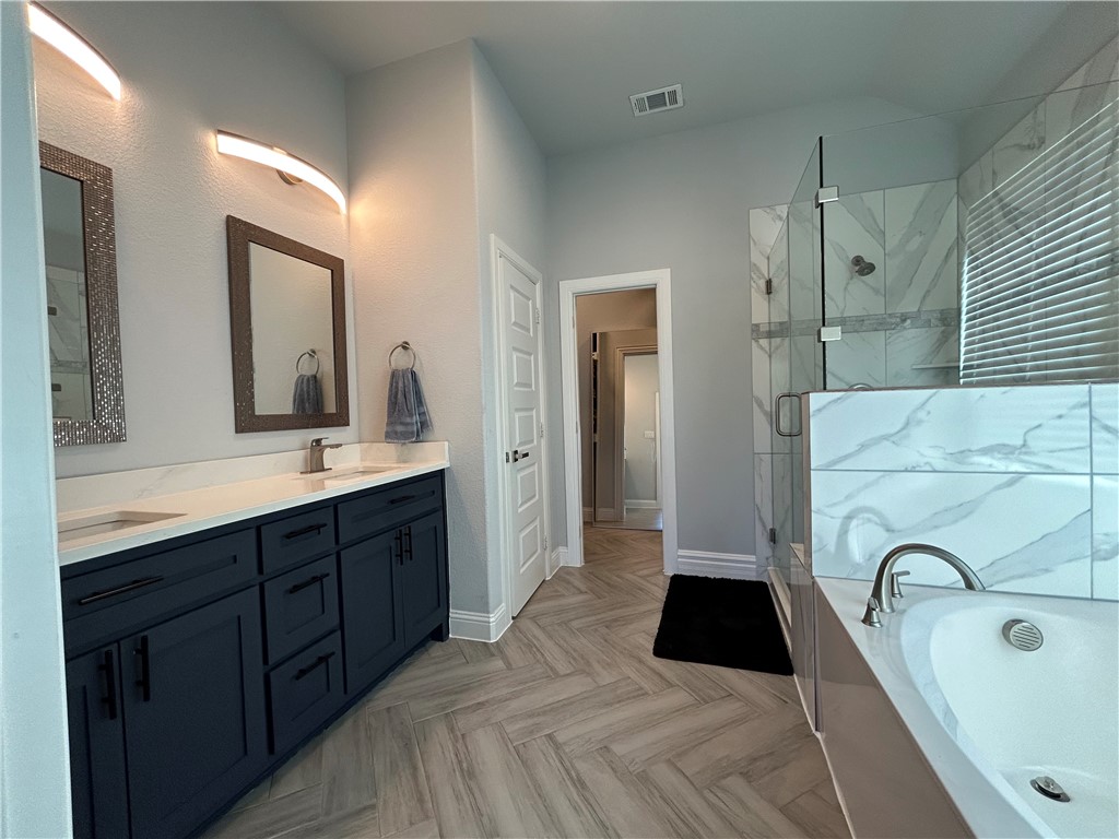 16664 County Road 3120 Road Northwest Purdon, TX 76679 - Photo 4 of 59 a bathroom with a double vanity sink double vanity and a mirror