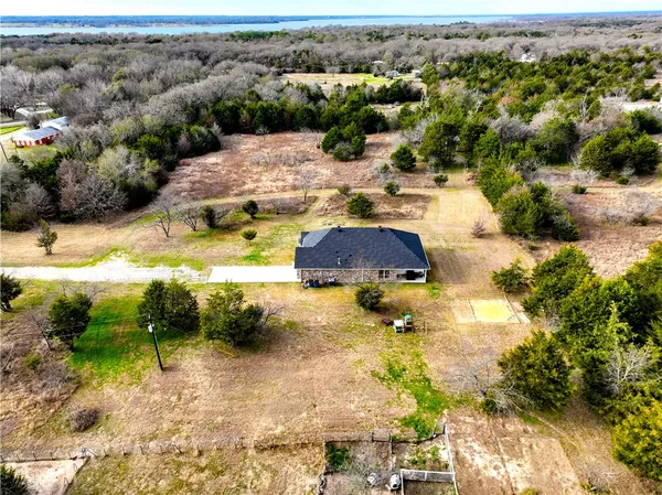 an aerial view of residential houses with yard