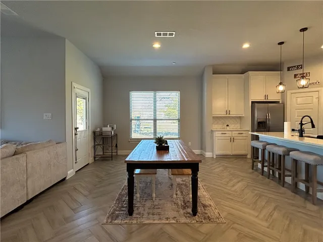 a kitchen with a sink cabinets and wooden floor