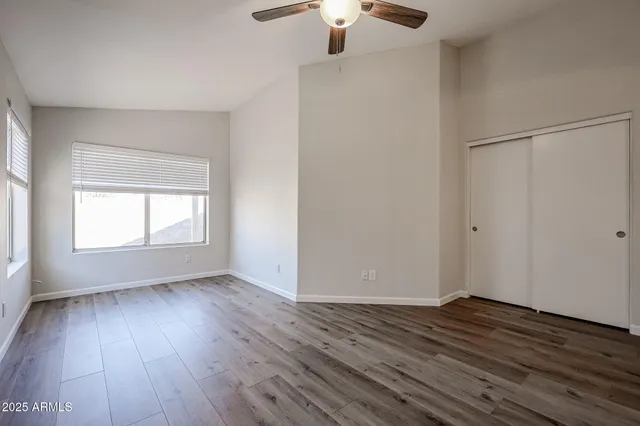 a view of empty room with wooden floor