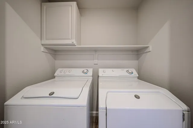 a bathroom with a double vanity sink toilet mirror and bathtub