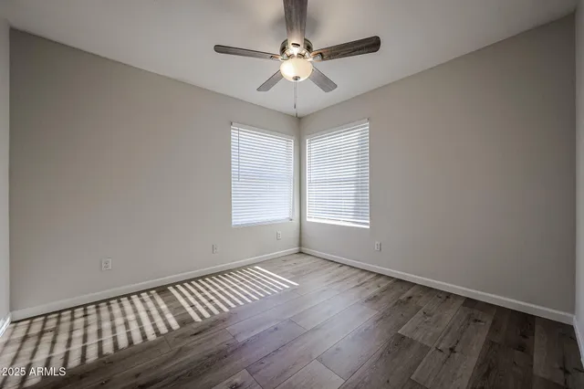a view of empty room with wooden floor