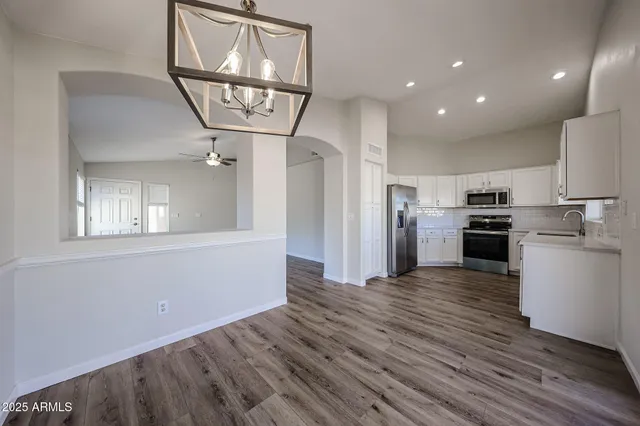 a kitchen with a stove top oven a refrigerator and cabinets