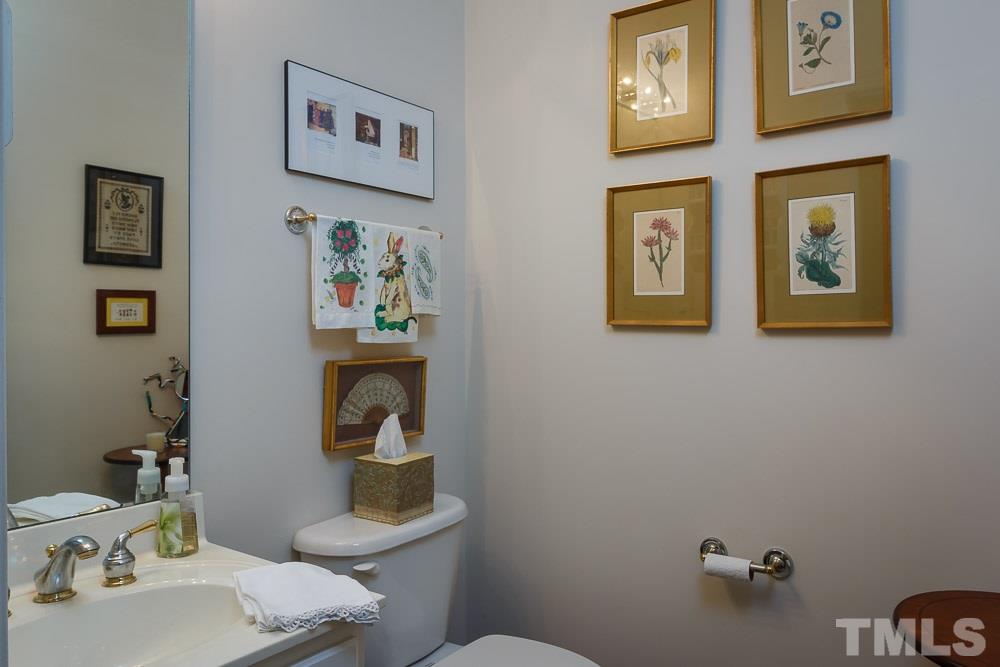 3618 Lion Ridge Court, Unit 83 Raleigh, NC 27612 - Photo 14 of 25 a bathroom with a sink and a mirror