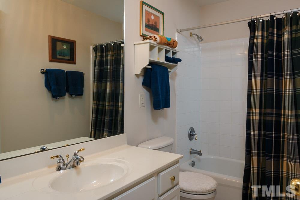 3618 Lion Ridge Court, Unit 83 Raleigh, NC 27612 - Photo 22 of 25 a bathroom with a sink toilet and shower