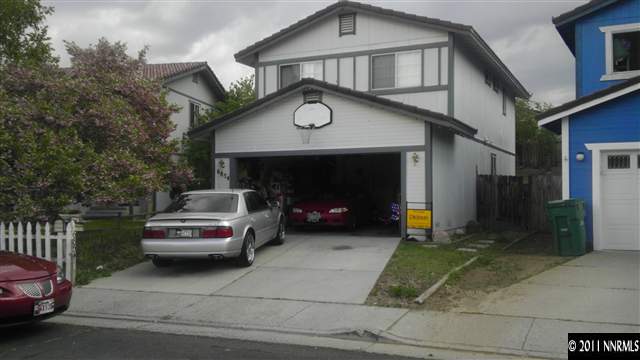 6854 Forsythia Way Reno, NV 89506 - Photo 1 of 1 a front view of a house with a garden and parking space
