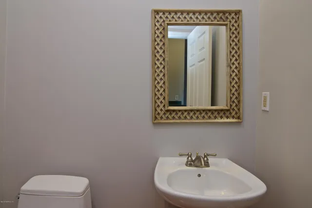 a view of an empty room with a window and a ceiling fan
