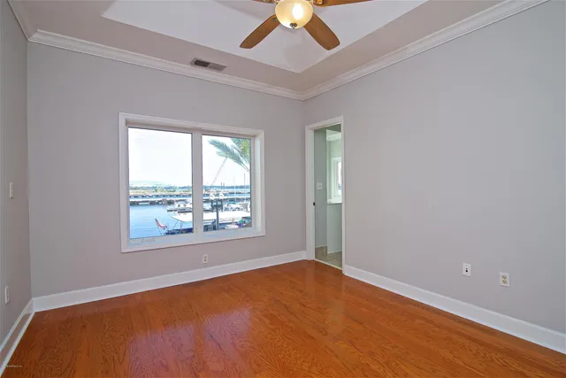 a view of a lake with boats and palm trees