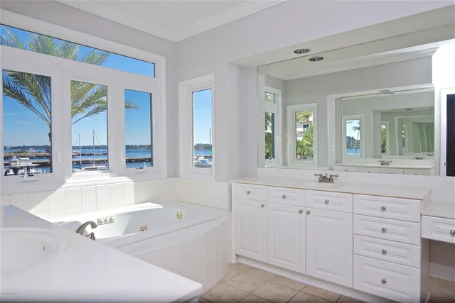 a spacious bathroom with a granite countertop tub sink and mirror