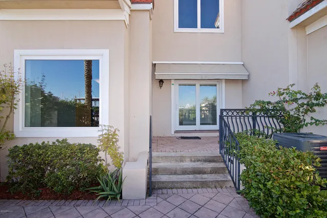 a living room with furniture a fireplace and a large window