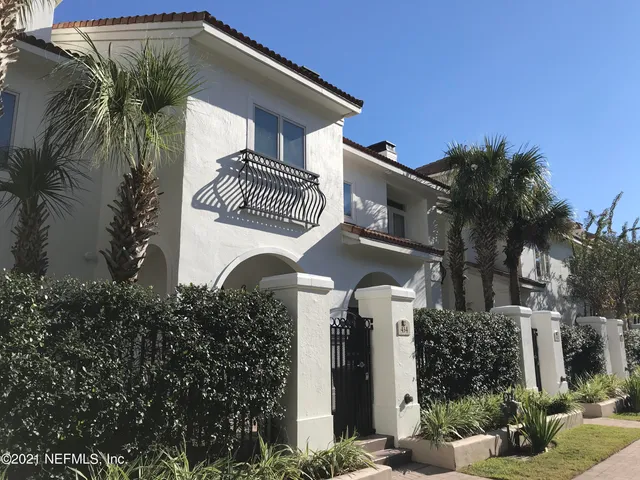 a view of a livingroom with an empty space a fireplace a ceiling fan and wooden floor