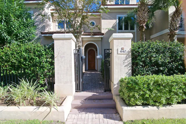 a view of an empty room with wooden floor fireplace and a window