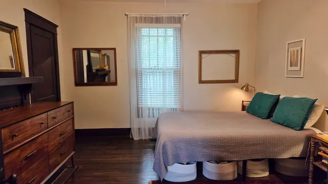 a bedroom with a bed and a flat screen tv