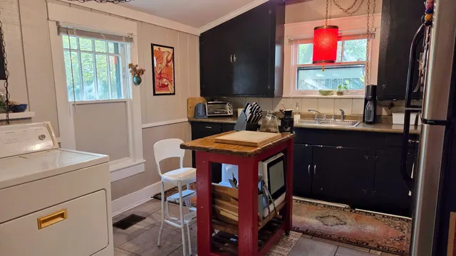 a bedroom with a bed and painting on the wall